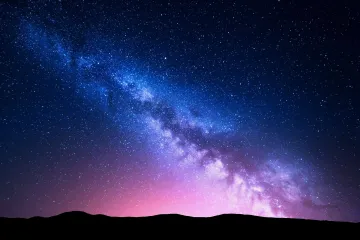milky-way-and-pink-light-at-mountains.-night-colorful-landscape.-592031250_5616x3744_7in_1.jpg