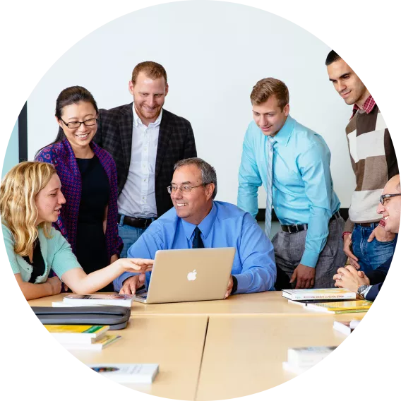 Peter Boettke with a group of students around a table